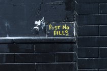 Post no bills, black wall — Stock Photo