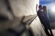 Verliebtes Paar küsst sich an einer Mauer — Stockfoto