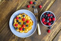 Waffle with blueberries and raspberries on plate — Stock Photo