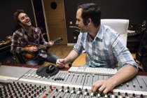 Guitar player and audio engineer in a recording studio — Stock Photo