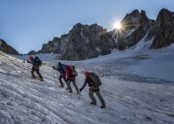 France, Chamonix, Argentiere Glacier, Les Droites, Les Courtes, Aiguille Verte, mountaineers climbing at dawn — Stock Photo
