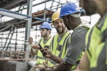 Construction workers having a break on construction site — Stock Photo