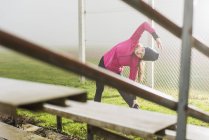 Mujer joven haciendo ejercicio en un campo de deportes - foto de stock