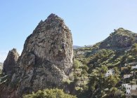 Spain, Canary Islands, La Gomera, two men climbing on rock — Stock Photo