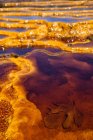 Ro Tinto, or Red River, very acidic and coloured deep red by iron dissolved in the water that drains from the local Riotinto mines causing severe environmental problems — Stock Photo