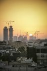 Israel, Tel Aviv, cityscape with cranes at sunset — Stock Photo