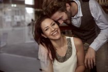 Happy young couple laughing in a cafe — Stock Photo