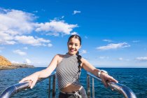Porträt einer lächelnden jungen Frau vor dem Meer — Stockfoto
