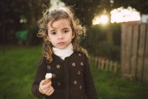 Portrait of little girl holding ice cream cone — Stock Photo