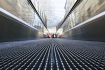 Moving walkway with people standing on background — Stock Photo