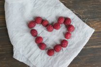 Heart shaped with fresh raspberries — Stock Photo