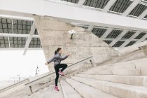 Woman jogging upstairs — Stock Photo