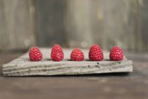 Fresh raspberries on wood — Stock Photo