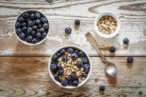 Top view of porridge with blueberries in bowls — Stock Photo