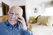 Hombre mayor telefoneando con teléfono inteligente - foto de stock