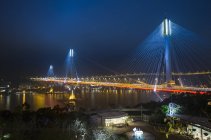 China, Hong Kong, view of bridge over water at night — Stock Photo