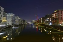 Germany, Frankfurt, Illuminated Westhafen at night — Stock Photo