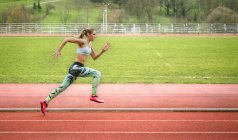 Spain, Woman running on racetrack — Stock Photo