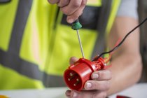Cropped image of Electrician fixing connector — Stock Photo