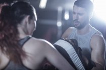 Coach with female boxer in boxing ring — Stock Photo