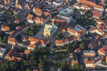 Germany, Lower Saxony, Hildesheim, aerial view with rooftops and Cathedral in evening light — Stock Photo