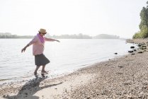 Germany, Ludwigshafen, senior woman walking out of Rhine River — Stock Photo