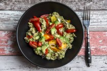 Bowl of avocado and tuna salad with tomatoes — Stock Photo