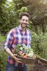 Man holding basket with mixed vegetables — Stock Photo