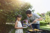 Caucasian family having a barbecue in garden — Stock Photo