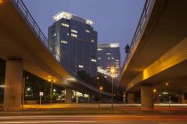 Germany, North Rhine-Westphalia, Essen, headquarters Evonik Industries, elevated road in the evening — Stock Photo