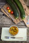 Zucchini chutney in jar on wooden table with ingredients — Stock Photo