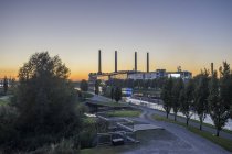 Germany, Lower Saxony, Wolfsburg, View of Autostadt in the evening, combined heat and power station of Volkswagen in the background — Stock Photo