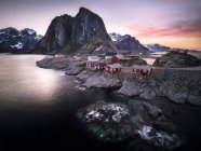 Norway, Lofoten, Hamnoy in the evening and view of rocks over water — Stock Photo