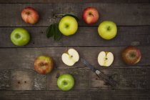 Green and red apples with knife — Stock Photo