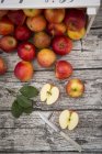 Whole and halved red apples — Stock Photo