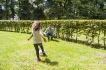 Father and daughter playing football in park — Stock Photo