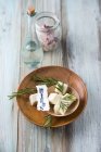 Bathpralines with herbs in bowl, rosemary, eucalyptus and pine, bath salt and rosewater — Stock Photo