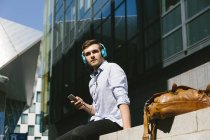Businessman listening music with headphones — Stock Photo