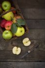 Red and green apples in basket — Stock Photo