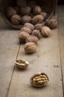 Cracked walnut on wood — Stock Photo