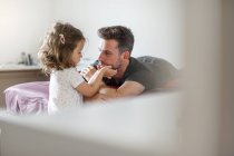 Father and daughter on bed — Stock Photo