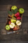 Green and red apples in basket — Stock Photo