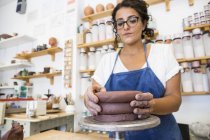 Woman working with clay in a ceramics workshop — Stock Photo