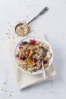 Bowl of soured milk with quinoa, fruit muesli, plums and raspberries — Stock Photo