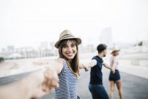 Woman holding hands with friends — Stock Photo