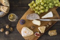 Cheese platter with camembert, walnut cheese, gorgonzola, taleggio and champagne — Stock Photo