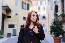 Italy, Verona, young woman in the city looking around — Stock Photo