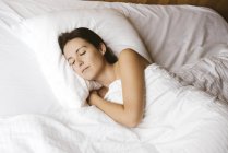 Portrait of sleeping woman in the bed — Stock Photo