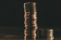Stack of coins on black background — Stock Photo