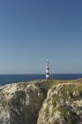 View to navigational light on the rock, Porto Covo, Algarve, Portugal — Stock Photo